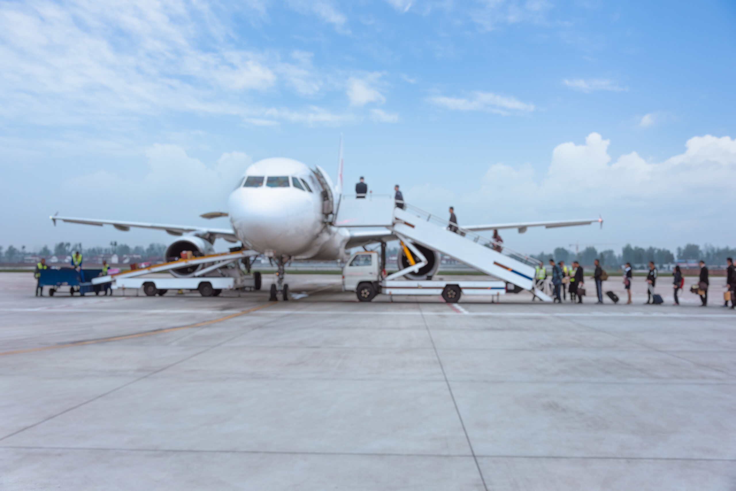 people boarding airplane on runway.